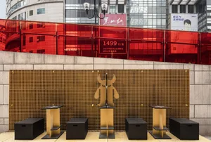 A modern and traditional space with wooden stools, red accents, and a blend of styles