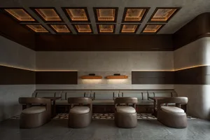 Comfortable seating area with multiple chairs and couches, well-lit with natural and artificial light, creating a relaxed atmosphere for socializing