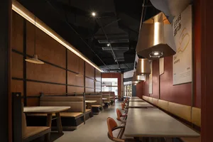 Empty restaurant interior with wooden tables and chairs, inviting atmosphere, and warm wooden elements