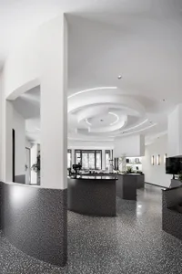 Spacious lobby with a circular design, potted plants, and modern decor