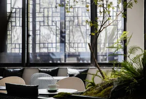 Cozy dining area with a table and chairs arranged for conversation, featuring two cups on the table