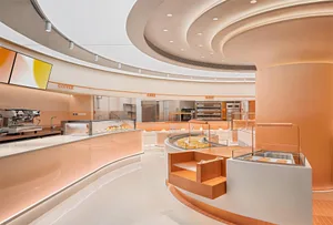 A well-equipped kitchen with a large dining table, comfortable seating, and modern appliances, set in a clean and organized space