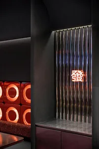 Modern interior design with a black doorway featuring a red frame, illuminated by two lights on each side