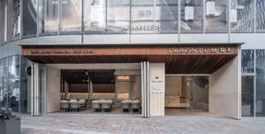 A restaurant dining area with multiple tables and chairs, wooden furniture, and an inviting atmosphere