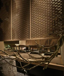 Warm and inviting interior design with wooden walls and ceilings, featuring chairs and a dining table in a modern setting
