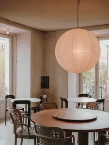 A restaurant dining area with a wooden table and four chairs, surrounded by a cozy atmosphere