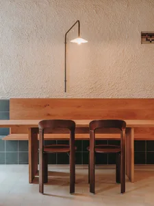 A dining area with a wooden table and chairs, surrounded by a cozy atmosphere for socializing and enjoying meals together
