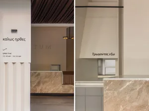 Interior space with marble floors and walls, contrasting with industrial concrete elements, in a modern and sophisticated atmosphere
