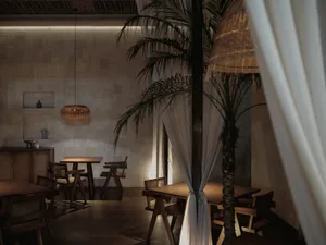 A well-lit dining area with a large wooden table surrounded by multiple chairs, creating a comfortable atmosphere for guests