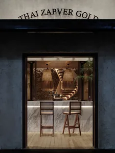 Modern kitchen with wooden bar stools and marble countertop, featuring a sink and two chairs, with a sophisticated atmosphere created by the use of wood and marble
