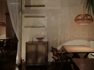 Warm and inviting dining space with a wooden table and chairs, a vase adding decorative touches