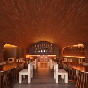 Warm and inviting dining space with wooden tables and chairs, surrounded by natural light