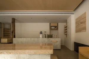 A modern coffee shop interior with a marble counter, two coffee machines, and two cups, featuring a stylish and luxurious atmosphere