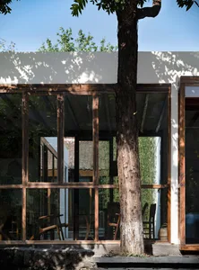 A well-lit dining area with a wooden table and chairs, creating a cozy atmosphere for gatherings and meals