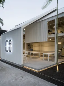 Modern restaurant interior with multiple dining tables and chairs, providing ample seating options for guests