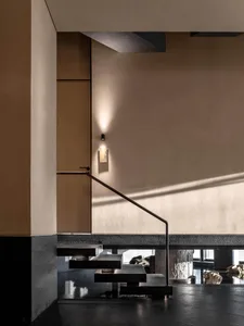 Modern staircase with metal steps, well-lit with clean lines and minimalistic design elements