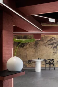 A modern dining space with a white table and black chairs, set in a minimalist atmosphere