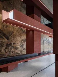 A warm and inviting interior design featuring a wooden countertop, chairs, and a book, set against a mountainous backdrop