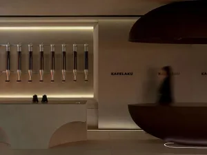 A modern interior design showroom featuring a wall display of multiple bottles in various positions, creating a visually appealing and organized presentation