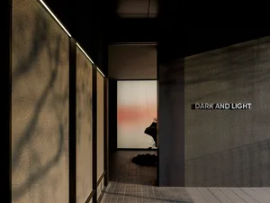 A dark and moody hallway with two sculptures, one near the left and one near the right, in a minimalist space with elegant artwork display