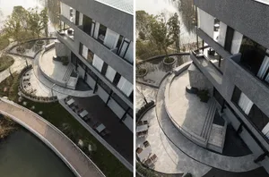 Modern hotel or resort with a circular patio area surrounded by chairs and dining tables, featuring a combination of concrete and glass elements