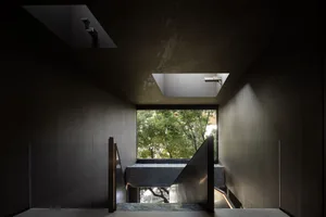 A traditional staircase with stone steps leading to a second floor, surrounded by a bright and inviting atmosphere
