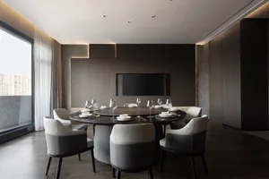 Dining area with a round table, multiple wine glasses, and comfortable seating for guests