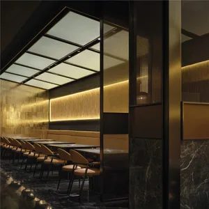 A modern dining space with a long wooden table surrounded by brown chairs in a well-lit room