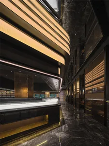 A luxurious hotel lobby with a marble bar, chairs, and a sophisticated atmosphere