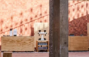 Industrial workspace with wooden crates, machinery, and tools, giving off a utilitarian atmosphere