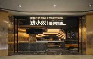 Modern Asian restaurant with a black marble countertop, natural light, and a TV mounted on the wall
