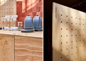 Modern kitchen design featuring wooden countertops, a coffee maker, and a decorative pegboard wall