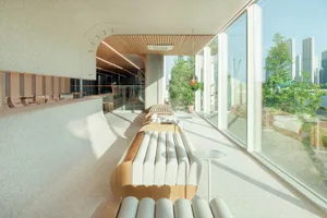 Open living area with large windows, seating options, dining tables, and a spacious atmosphere