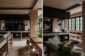 Warm and inviting open kitchen with wooden floors and walls, featuring a dining table, chairs, and countertop with various items on display