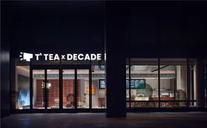 Inviting cafe interior with wooden chairs, tables, and a potted plant, perfect for a meal or tea