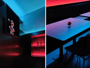 A lively restaurant dining area with a bar, featuring red and blue scenes with chairs, tables, bottles, and a bench, creating a social atmosphere