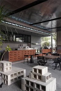 Inviting restaurant interior with a bar, chairs, and dining tables, featuring cups and a comfortable atmosphere