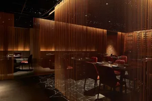 A modern restaurant with several tables and chairs, creating an inviting and comfortable atmosphere with a focus on functionality and contemporary aesthetics