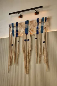 A wall adorned with various lengths of fabric, arranged in a creative pattern to enhance the interior space