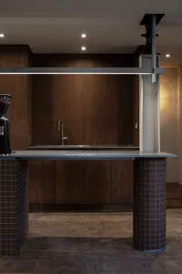 A modern kitchen with a marble countertop, cabinets, and a sink, featuring a sophisticated design