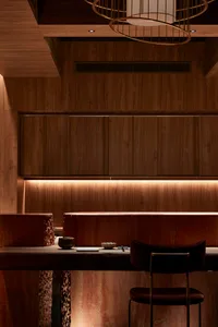 A cozy dining area with a wooden table and chairs, two couches, and a warm atmosphere, perfect for gatherings and meals