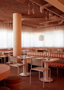 elegant dining space with wooden tables and chairs, wine glasses, and a comfortable atmosphere