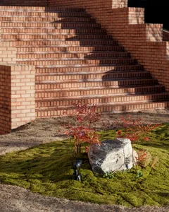 A brick staircase with three potted plants placed near the stairs, creating a calm and inviting atmosphere