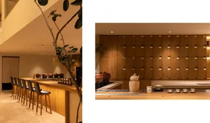 A kitchen with wooden cabinets, countertops, and storage options, featuring potted plants and various decorative items