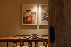 A warm and inviting dining area with wooden tables and chairs, traditional Asian design elements, and a cozy atmosphere