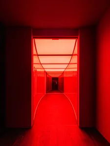 A modern hotel hallway with wooden accents, red walls, and a warm atmosphere