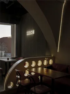 A modern dining area with three round tables and comfortable chairs, creating an inviting and stylish atmosphere