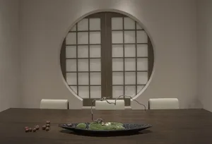 Elegant dining space with a wooden table, chairs, and a bowl on the table, surrounded by simplicity and harmony
