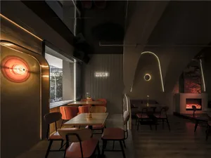 Cozy restaurant interior with multiple tables, chairs, and couches, perfect for dining and socializing
