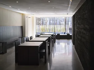 A modern restaurant interior with multiple tables and chairs, clean and well-organized, ready for guests